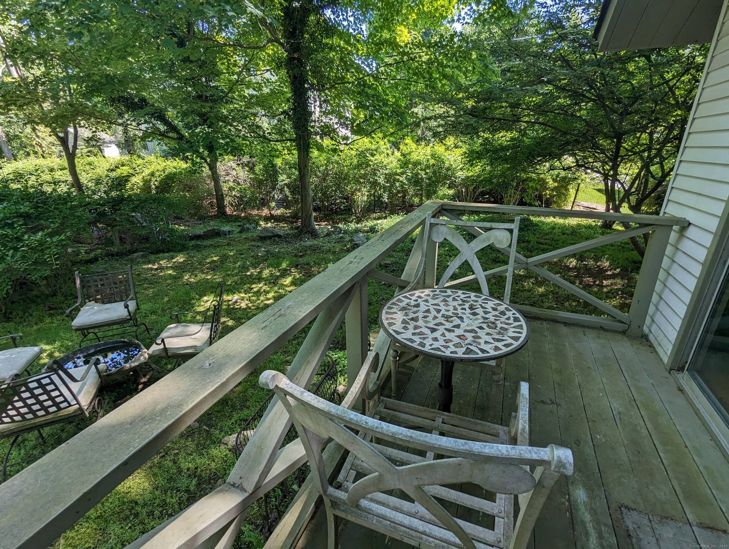3 Wild Rose Lane, Unit COTTAGE Darien, CT 06820 - Photo 13 of 16 a view of a balcony with two chairs and a table