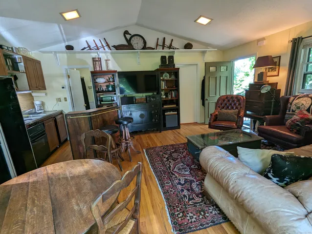 a living room with lots of furniture and wooden floor