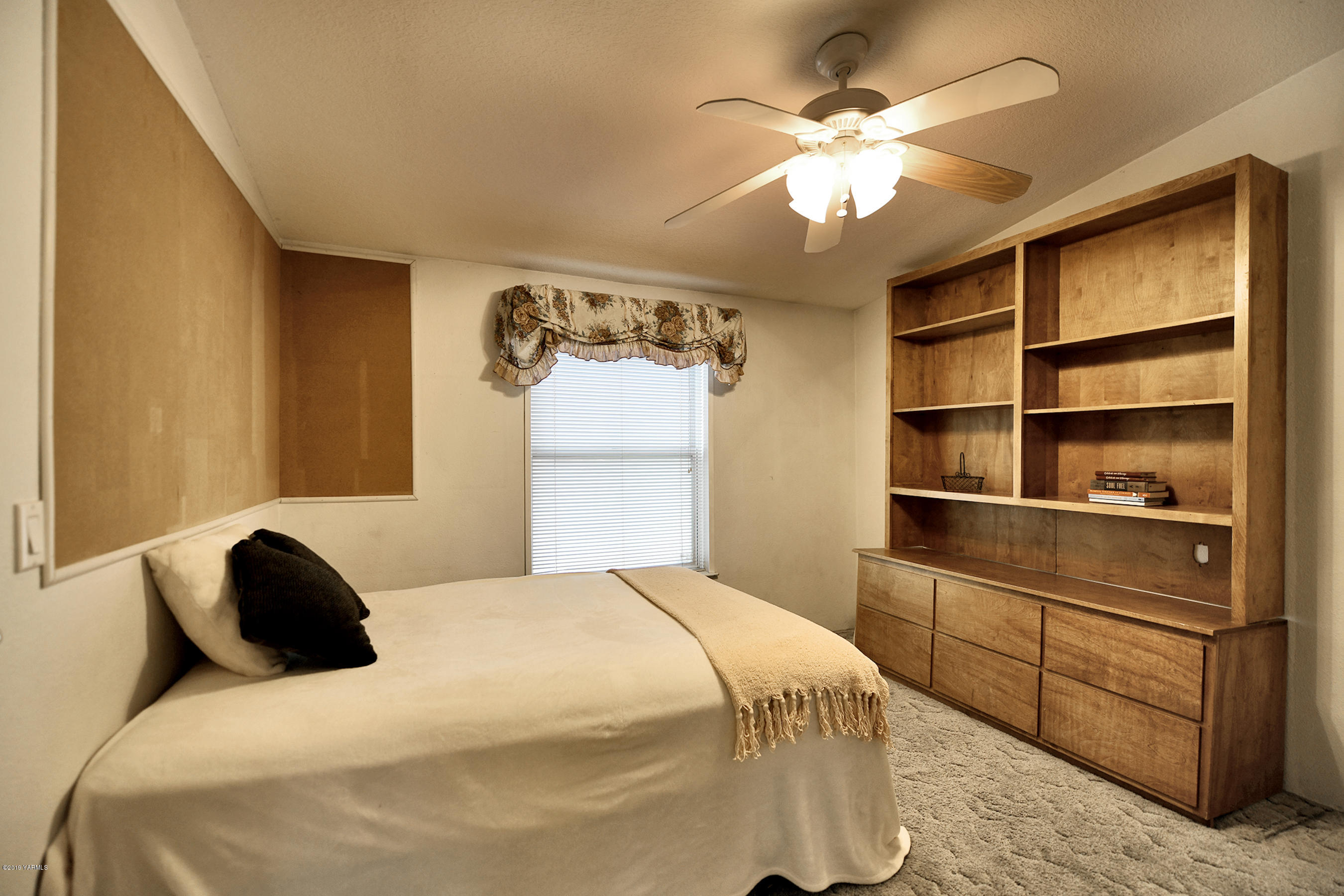 1251 Stone Road Yakima, WA 98908 - Photo 11 of 17 a bedroom with a bed and a chandelier