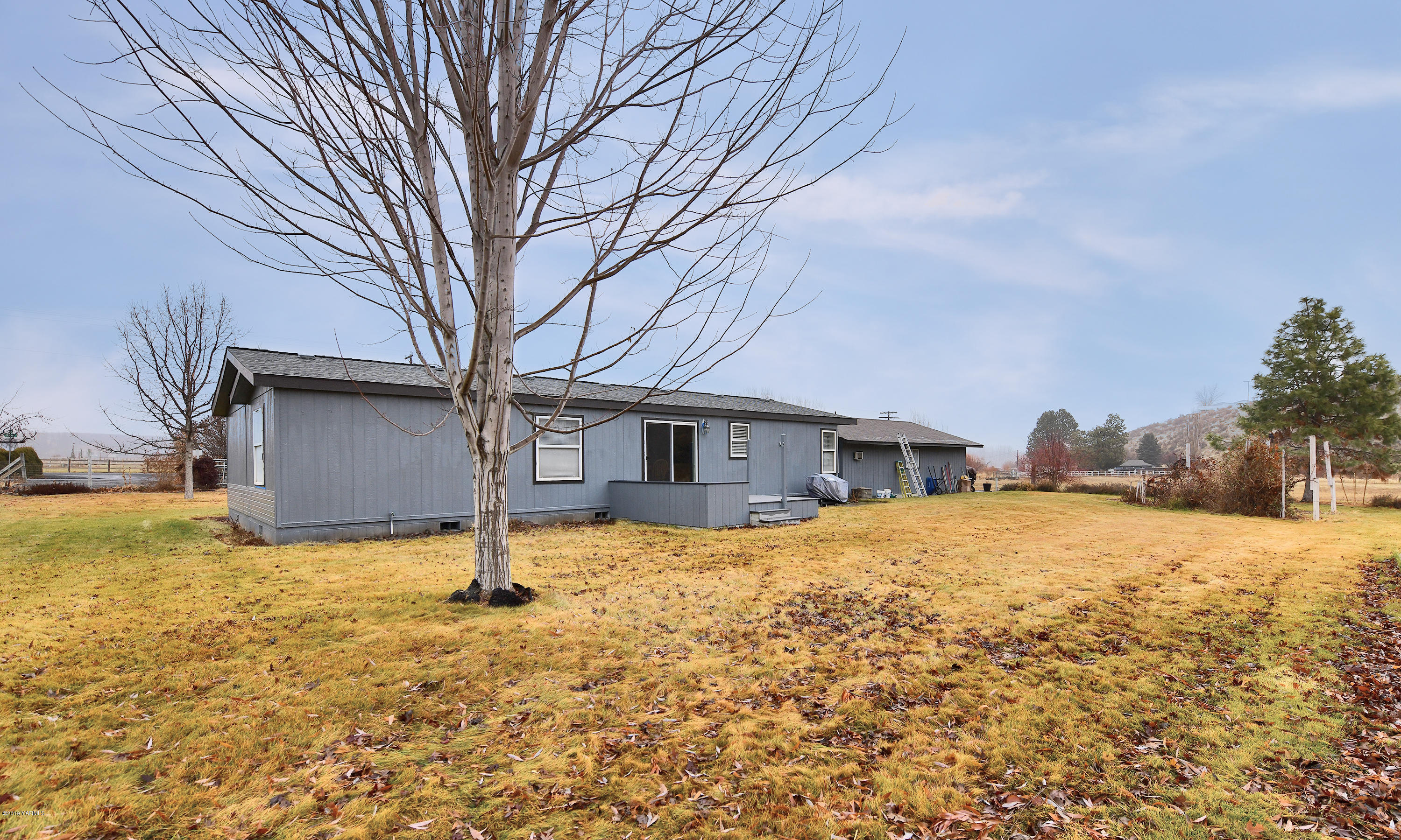 1251 Stone Road Yakima, WA 98908 - Photo 17 of 17 a house that has a tree in front of it