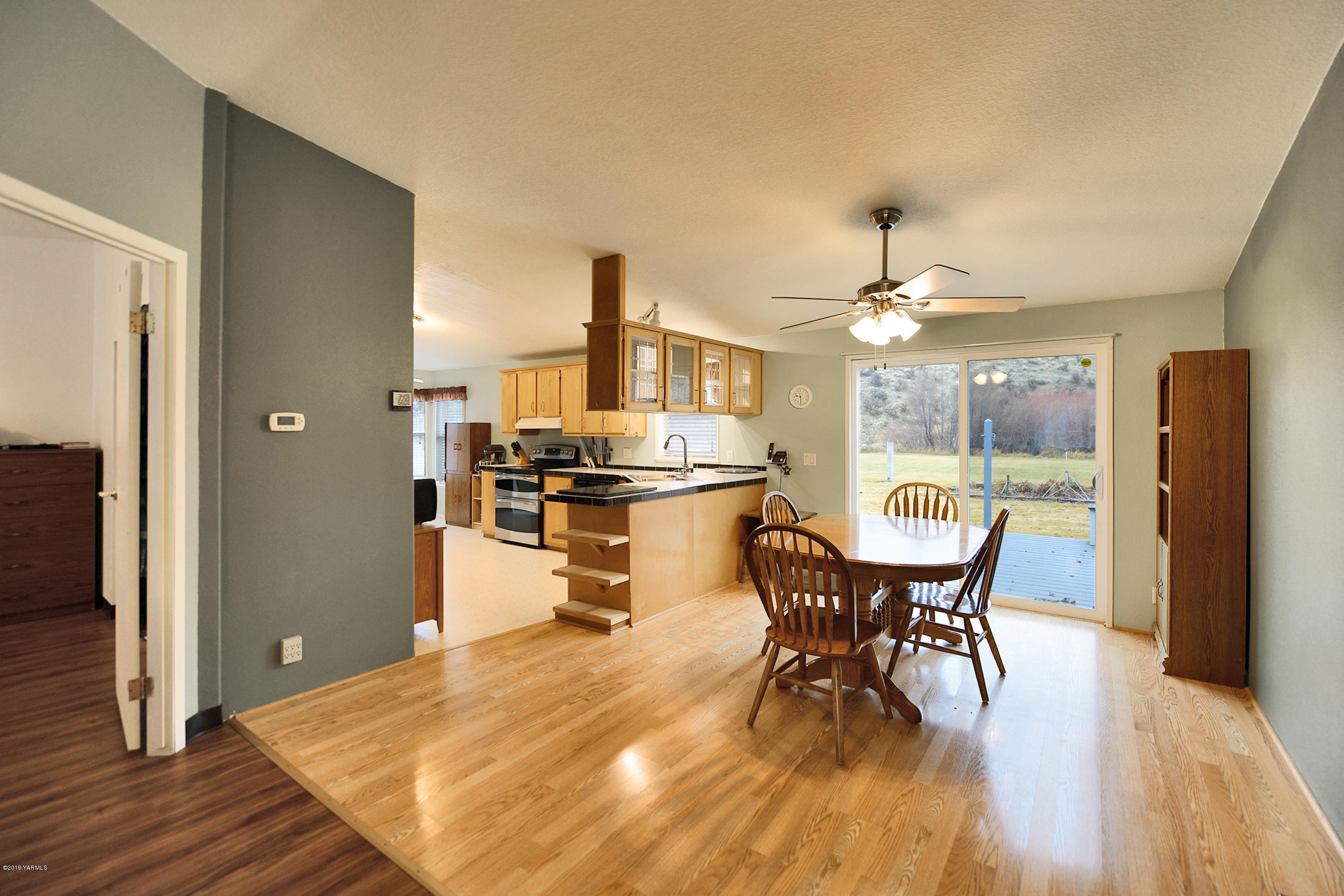 1251 Stone Road Yakima, WA 98908 - Photo 3 of 17 a kitchen with stainless steel appliances a dining table chairs and wooden floor
