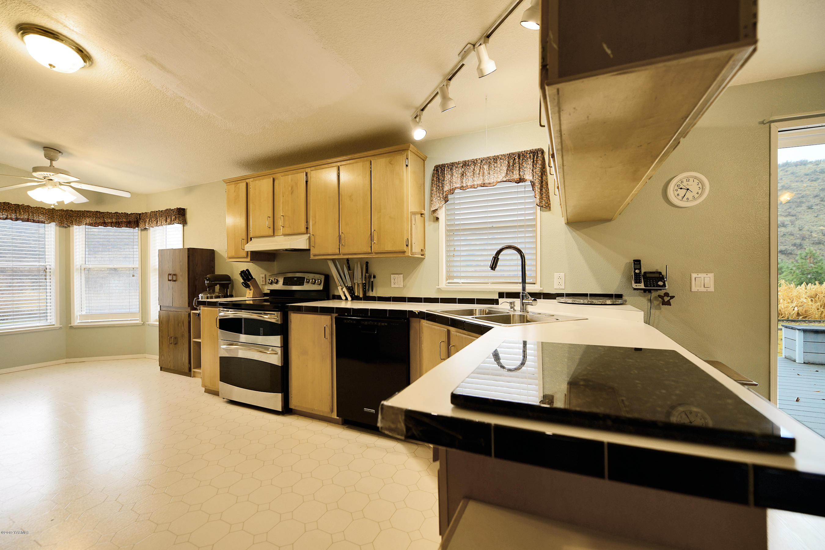 1251 Stone Road Yakima, WA 98908 - Photo 4 of 17 a kitchen with a sink a stove and cabinets
