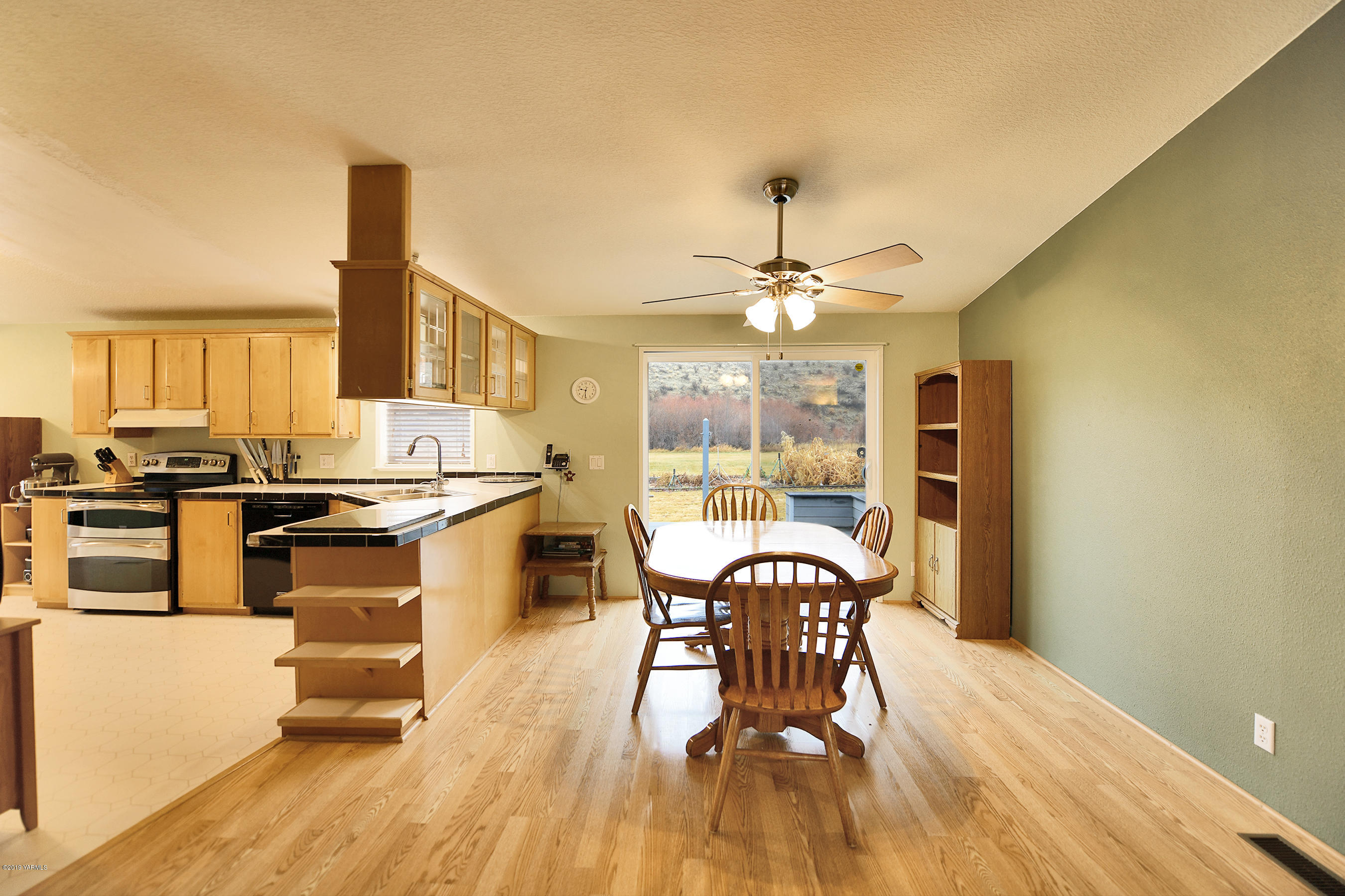 1251 Stone Road Yakima, WA 98908 - Photo 6 of 17 a view of a dining room with furniture and wooden floor