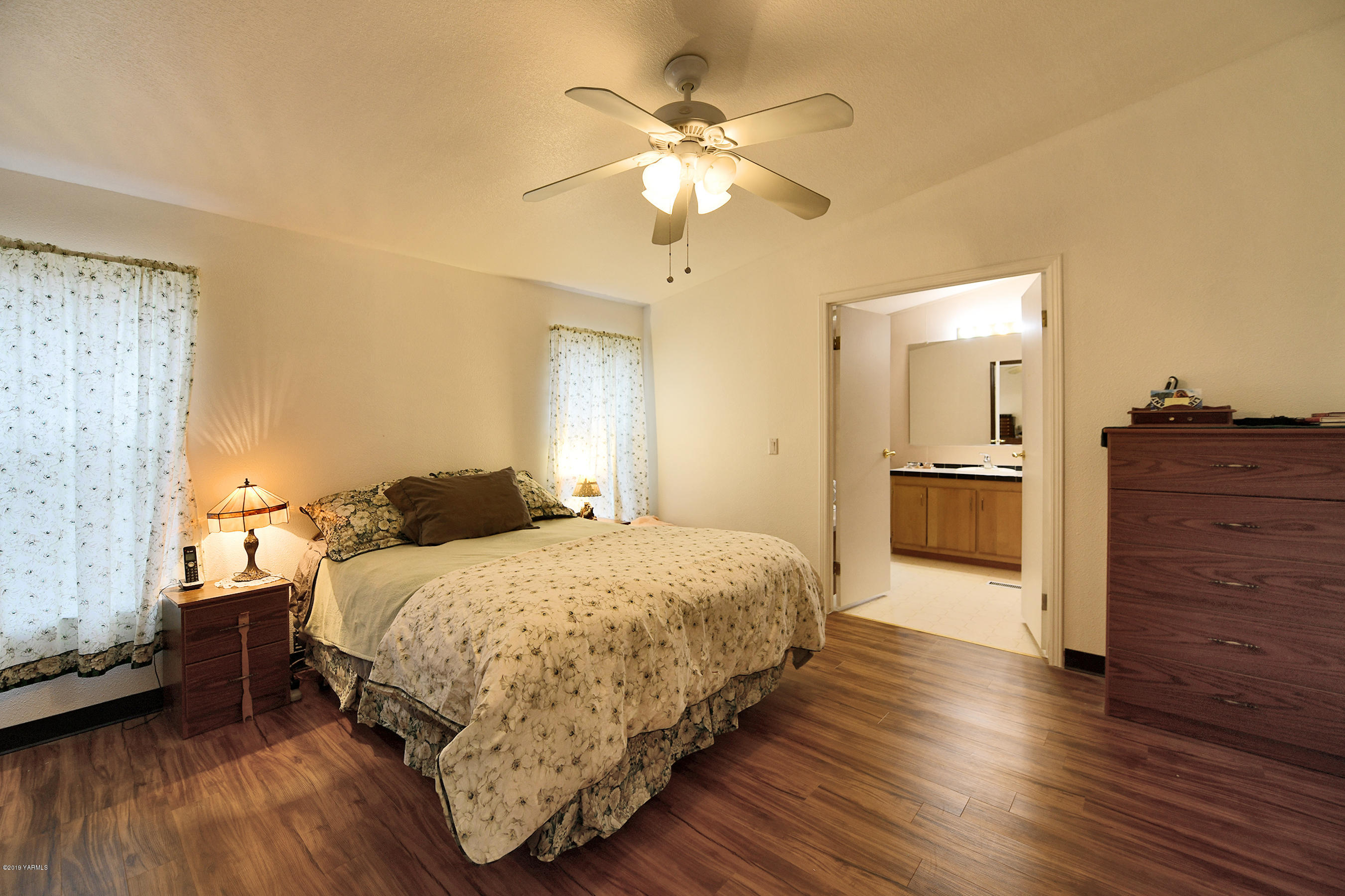 1251 Stone Road Yakima, WA 98908 - Photo 9 of 17 a bedroom with a bed and wooden floor