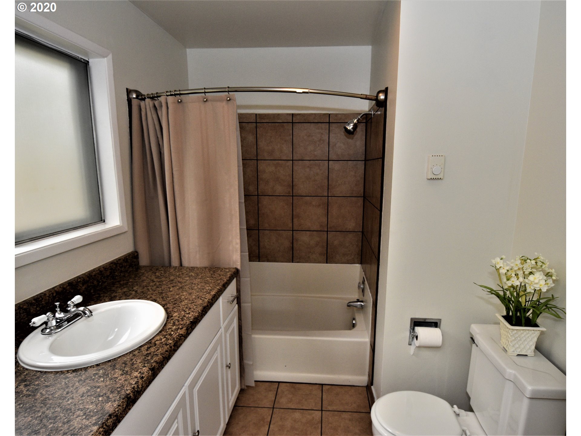 1506 Southwest Broadway Drive Portland, OR 97201 - Photo 14 of 18 a bathroom with a granite countertop sink toilet and shower