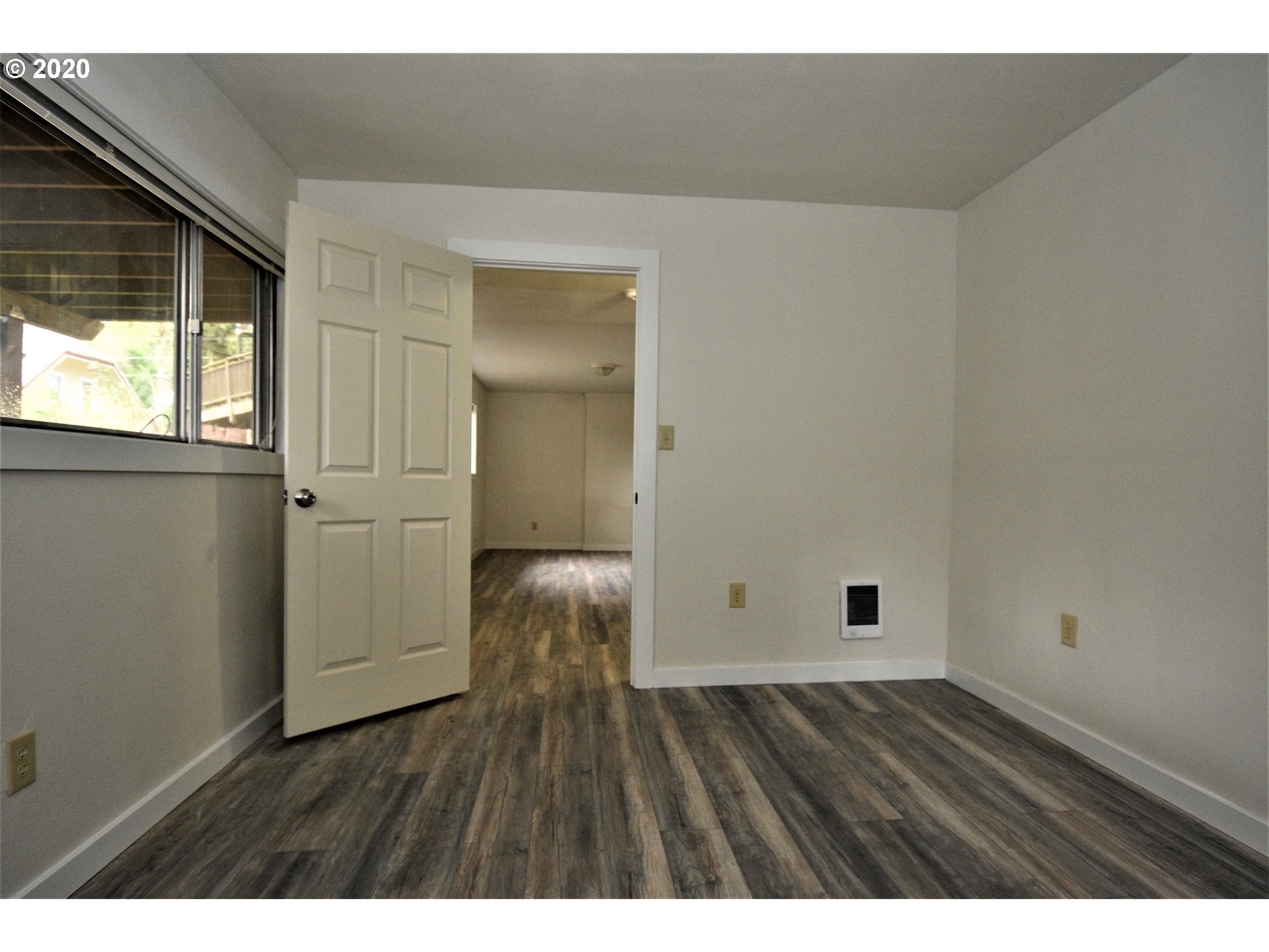 1506 Southwest Broadway Drive Portland, OR 97201 - Photo 16 of 18 a view of an empty room with wooden floor and a window