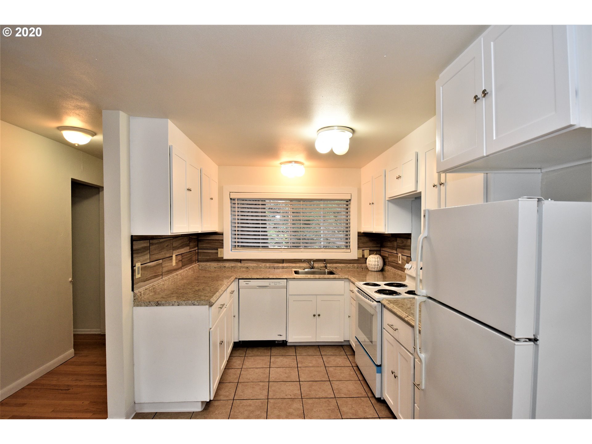 1506 Southwest Broadway Drive Portland, OR 97201 - Photo 4 of 18 a kitchen with a refrigerator a sink and cabinets