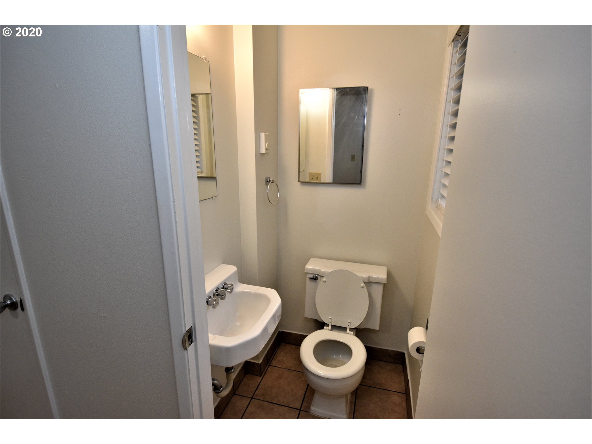 1506 Southwest Broadway Drive Portland, OR 97201 - Photo 9 of 18 a bathroom with a toilet a sink and mirror