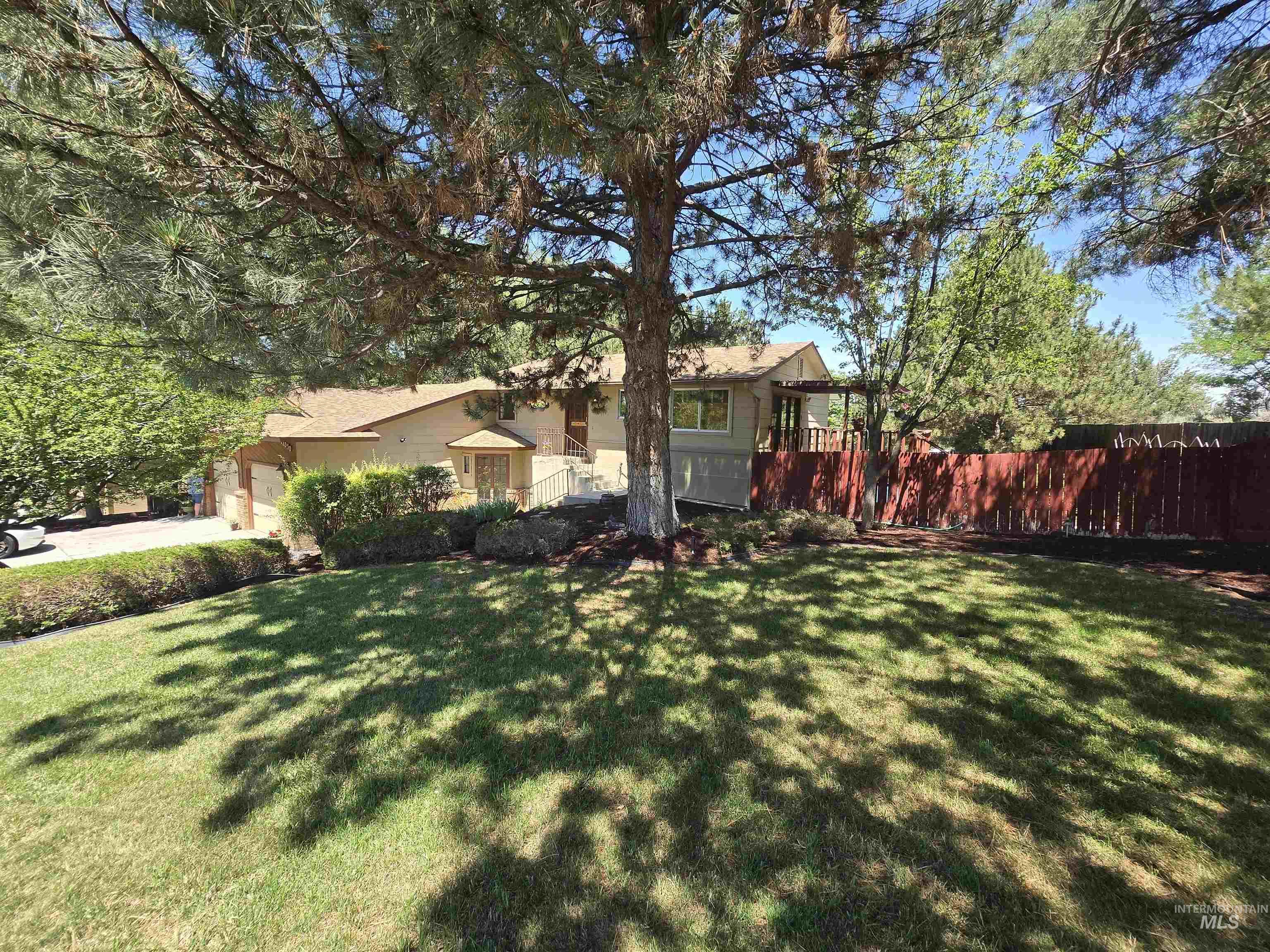 12050 West Hidden Valley Rim Road Boise, ID 83709 - Photo 1 of 39 Spacious front yard with mature trees and established landscaping