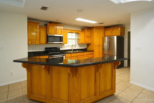 a living room with furniture and view of kitchen
