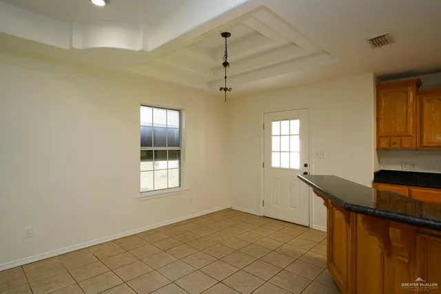 a kitchen with stainless steel appliances granite countertop a sink and a refrigerator
