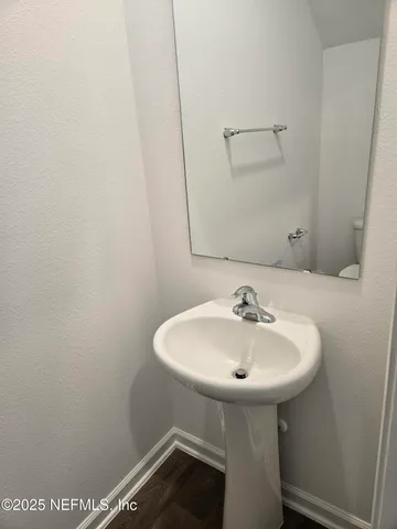 a white toilet sitting next to a shower