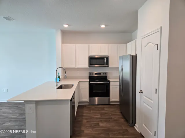 a kitchen with a refrigerator and a sink