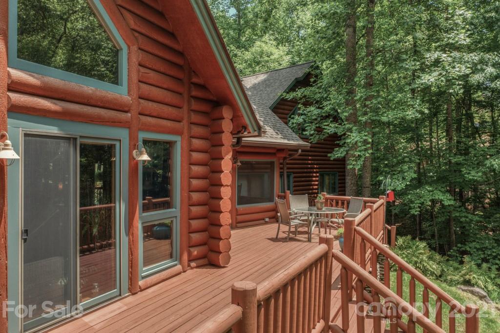 906 Pkwy N Road Mill Spring, NC 28756 - Photo 3 of 44 a view of house with outdoor seating and trees