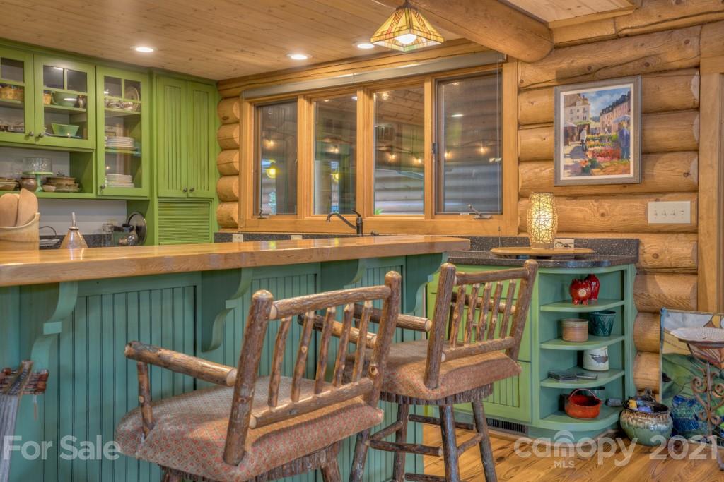 906 Pkwy N Road Mill Spring, NC 28756 - Photo 22 of 44 a kitchen with a stove a sink and a dining table