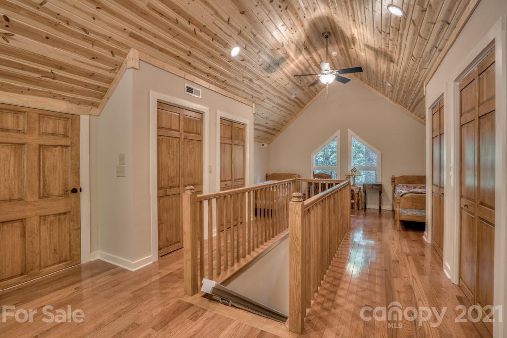 906 Pkwy N Road Mill Spring, NC 28756 - Photo 40 of 44 a view of a hallway with wooden floor and staircase