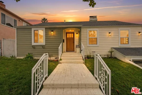 a view of a brick house with many windows