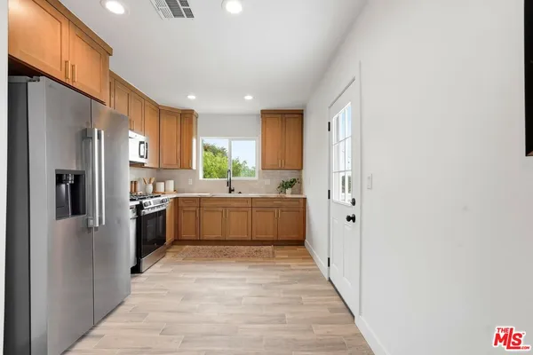 a kitchen with a sink stove and refrigerator