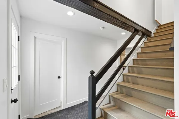 a kitchen with a stove and a wooden floor