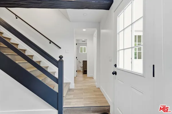 a kitchen with granite countertop a sink a stove and refrigerator