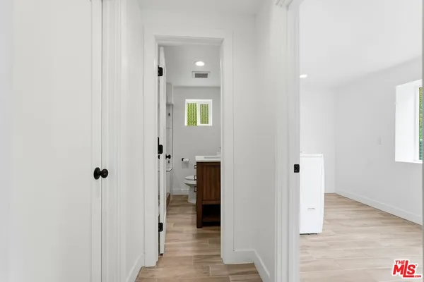 a view of an empty room with a fireplace and a window