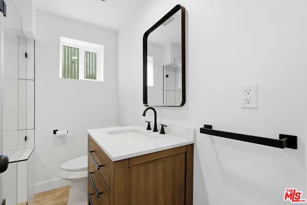 a view of an empty room with a fireplace and a window