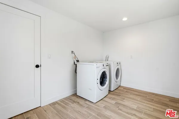 a backyard of a house with barbeque oven and trees