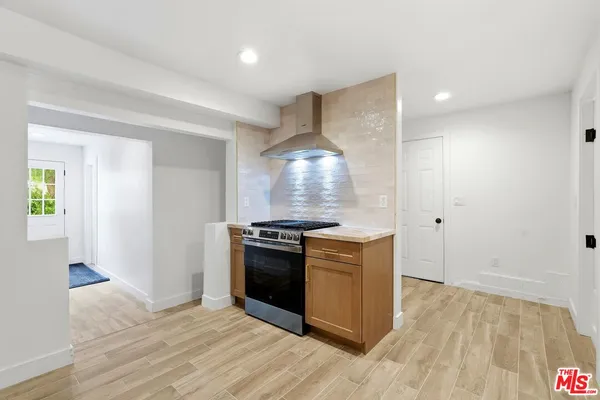 a view of a yard with plants and trees