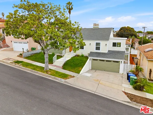 an aerial view of a house with a yard and potted plants