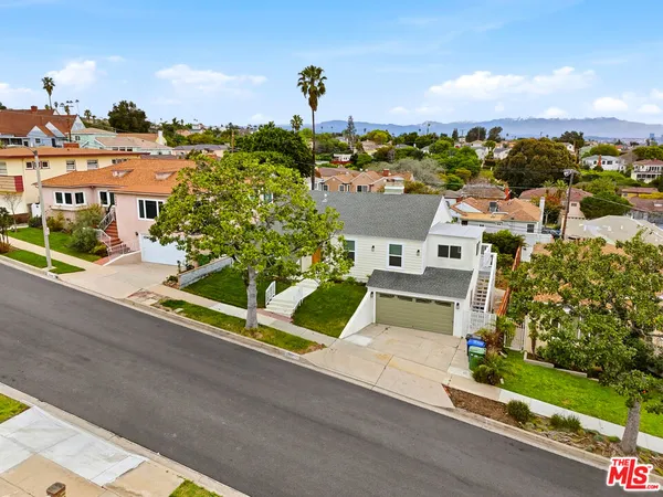 an aerial view of a house with a garden and plants
