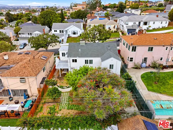 an aerial view of residential houses with outdoor space