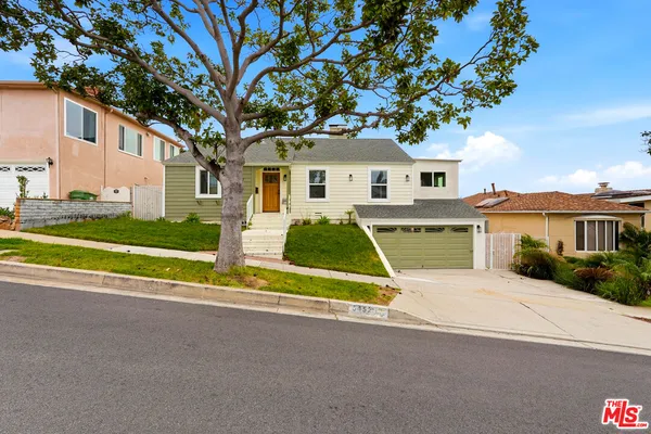 a house with a tree in front of it