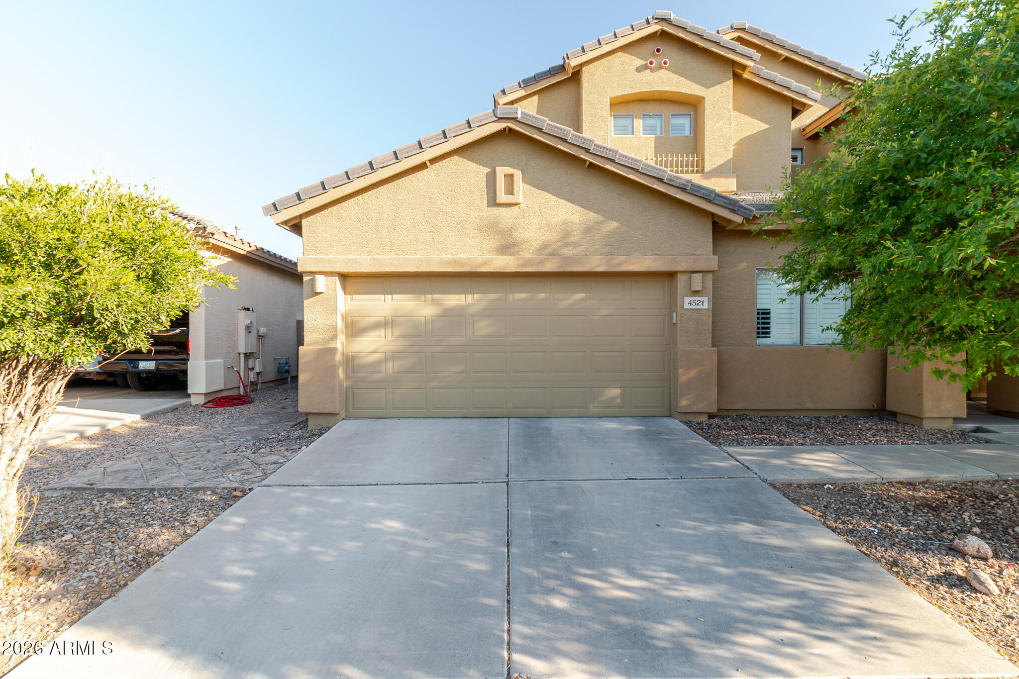 4521 West Moss Springs Road Anthem, AZ 85086 - Photo 7 of 35 a front view of a house with a yard and trees