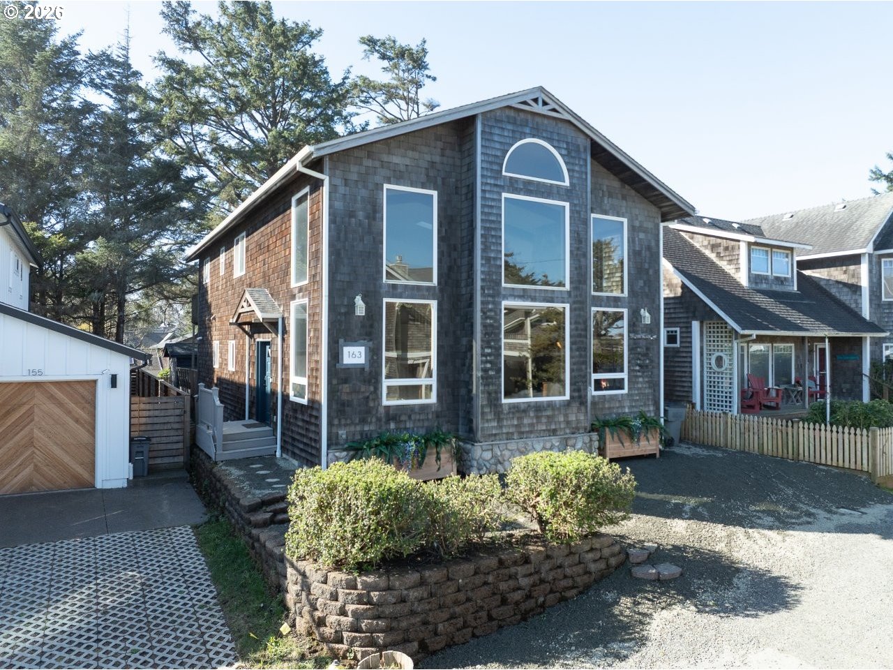 163 West 1st Street Cannon Beach, OR 97110 - Photo 1 of 42 a front view of a house with a yard