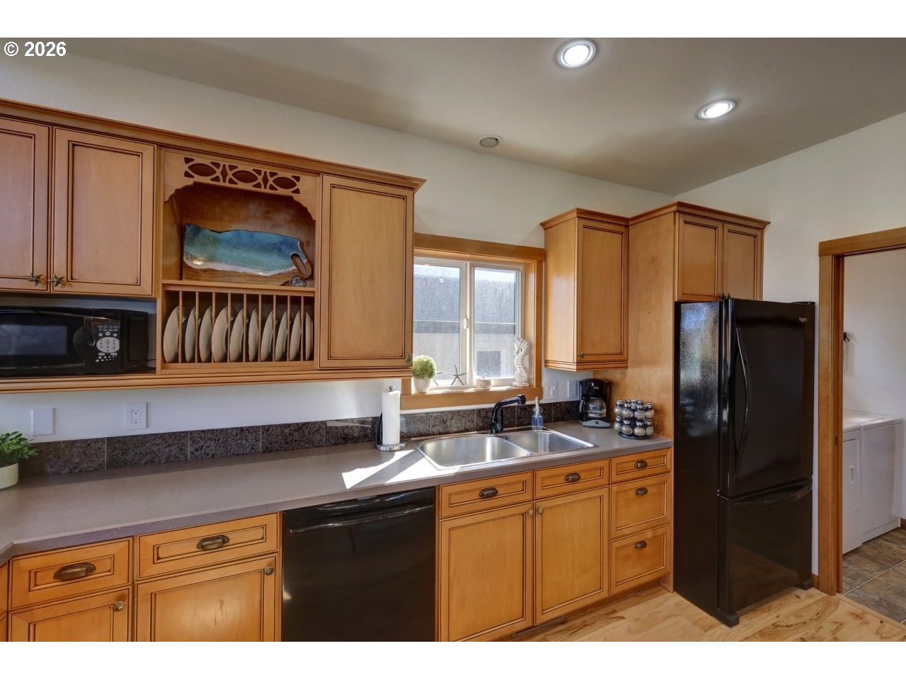 163 West 1st Street Cannon Beach, OR 97110 - Photo 11 of 42 a kitchen with stainless steel appliances granite countertop a refrigerator and a sink
