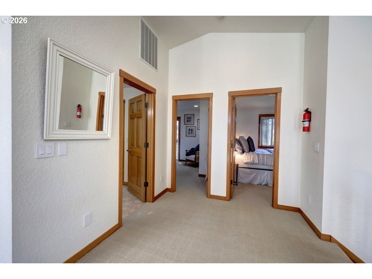 163 West 1st Street Cannon Beach, OR 97110 - Photo 26 of 42 a view of a bedroom from a hallway