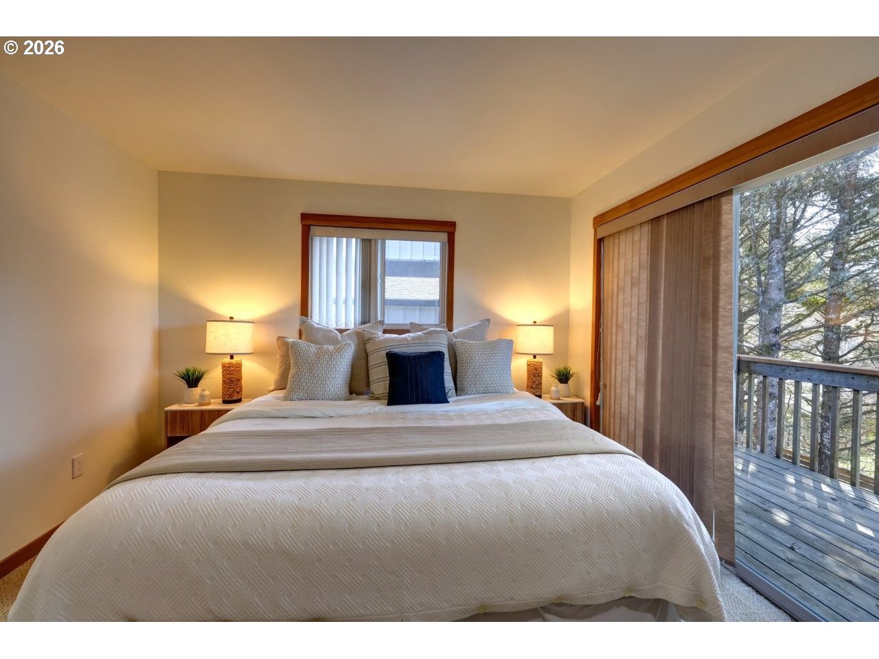 163 West 1st Street Cannon Beach, OR 97110 - Photo 28 of 42 a bedroom with a large bed and wooden floor
