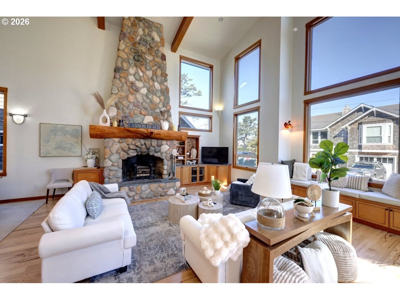163 West 1st Street Cannon Beach, OR 97110 - Photo 3 of 42 a living room with furniture a fireplace and a large mirror
