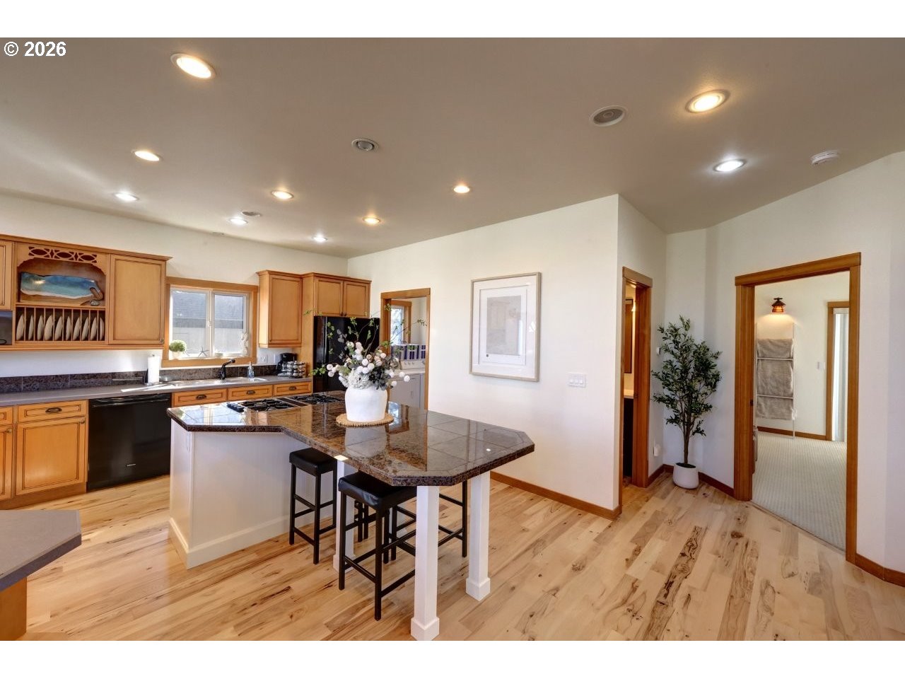 163 West 1st Street Cannon Beach, OR 97110 - Photo 9 of 42 a open kitchen with a sink and refrigerator