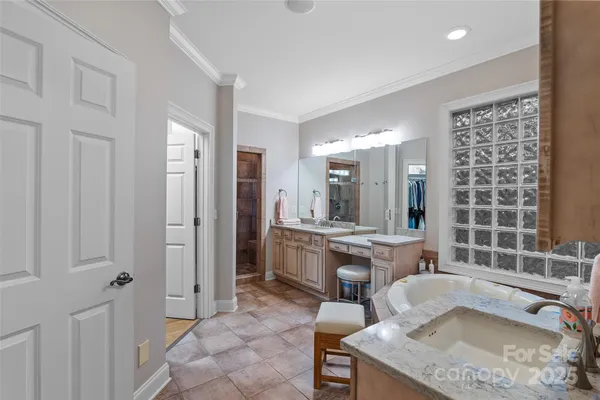 a bathroom with a granite countertop sink a toilet a mirror and shower