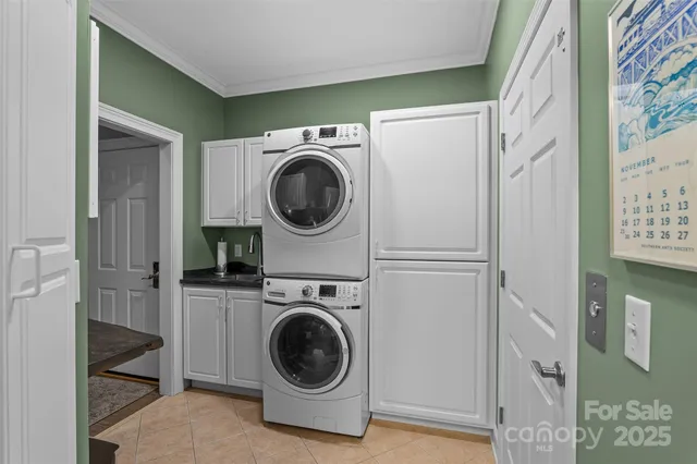 a utility room with sink dryer and washer