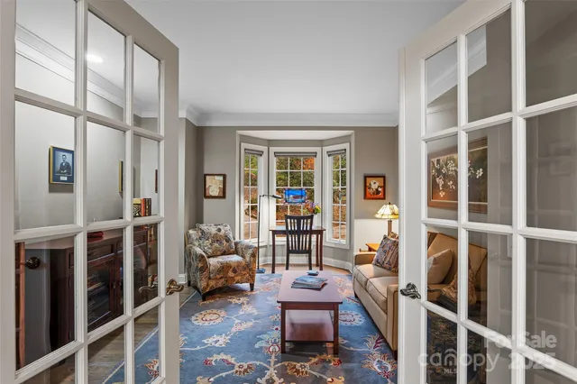 a living room with furniture a lamp and a bookshelf
