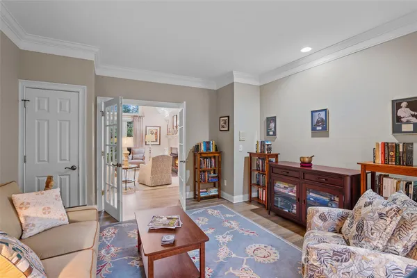 a bedroom with a bed and a dresser next to a window