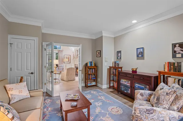 a bedroom with a bed and a dresser next to a window