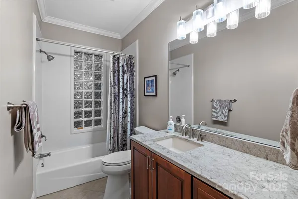 a bathroom with a sink mirror and vanity