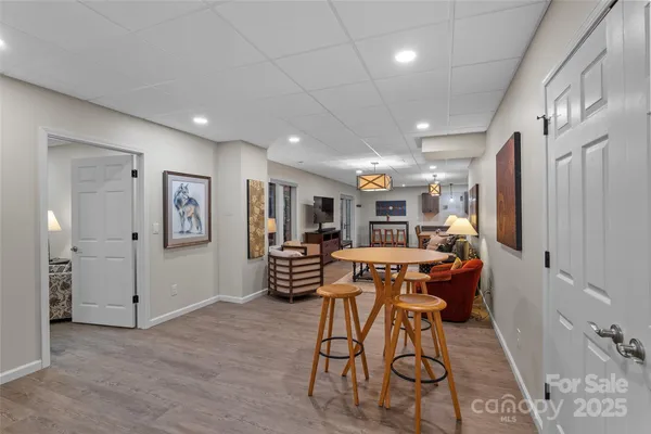 a living room with furniture a flat screen tv and a large window
