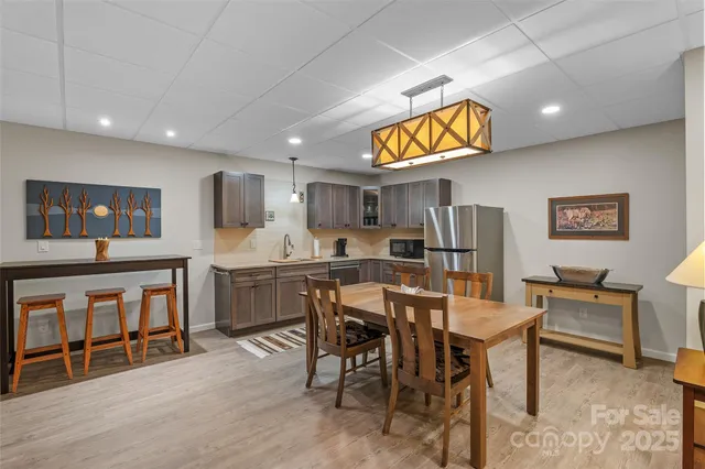 a kitchen with a sink a refrigerator and cabinets