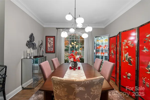 a view of a dining room with furniture and chandelier