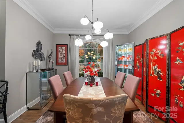 a view of a dining room with furniture and chandelier