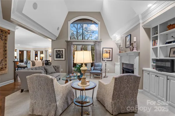 a living room with fireplace furniture and a large window